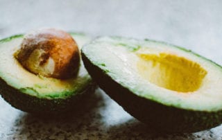 Avocados cut in half about to be made into salsa