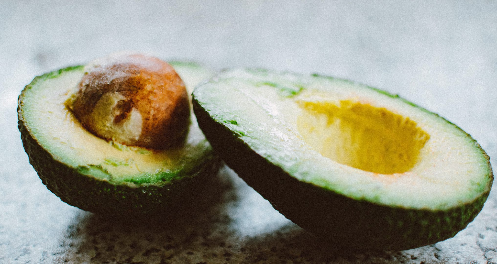 Avocados cut in half about to be made into salsa