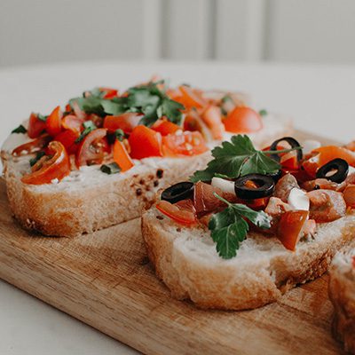 Grape-Tomato-Bruschetta-on-wood-cutting-board